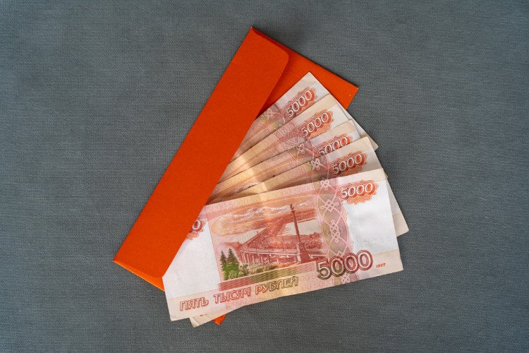 Пятитысячные купюры в конверте для денег